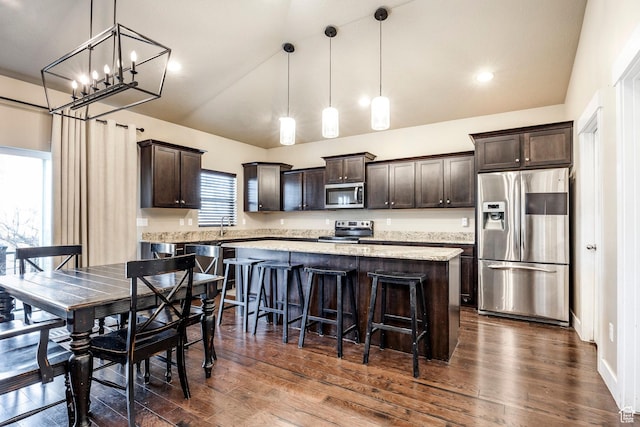 7104 S Cadens Cv, Cottonwood Heights, UT 84121 - kitchen featuring decorative light fixtures, a center island, and appliances with stainless steel finishes