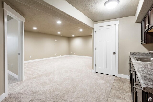 7104 S Cadens Cv, Cottonwood Heights, UT 84121 - kitchen with a sink, recessed lighting, a textured ceiling, dark brown cabinetry, and baseboards
