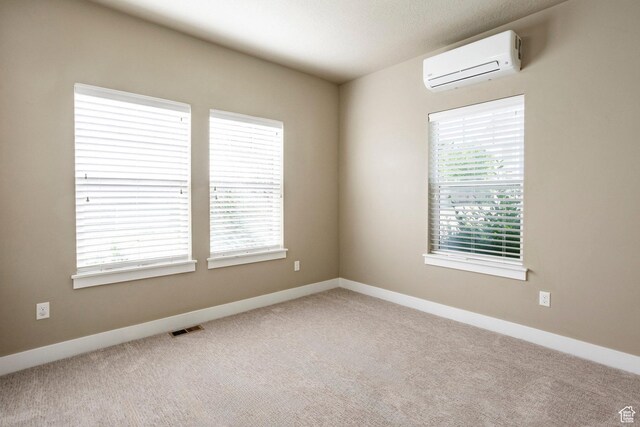 7104 S Cadens Cv, Cottonwood Heights, UT 84121 - empty room with an AC wall unit, plenty of natural light, and carpet floors