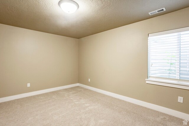 7104 S Cadens Cv, Cottonwood Heights, UT 84121 - empty room featuring light colored carpet, a textured ceiling, and baseboards