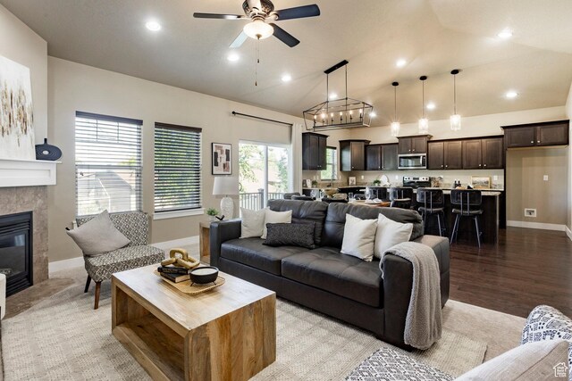 7104 S Cadens Cv, Cottonwood Heights, UT 84121 - living area featuring baseboards, a ceiling fan, a tiled fireplace, recessed lighting, and vaulted ceiling