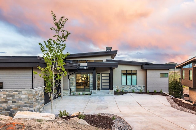 1817 W Skyridge Dr, Heber City, UT 84032 - back of house at dusk with stone siding and a patio