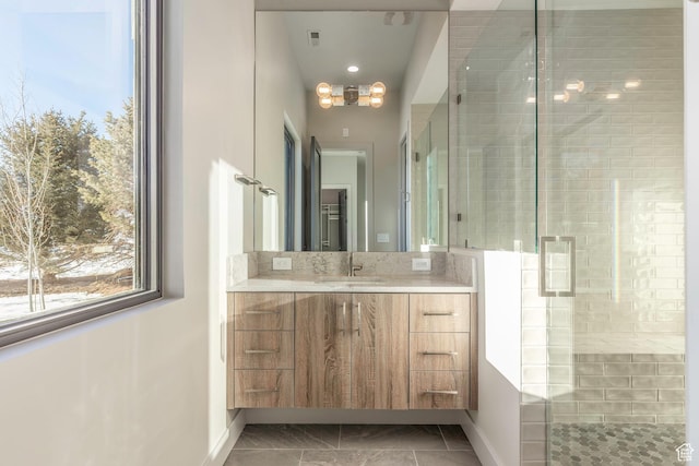 bathroom with vanity and a shower with shower door