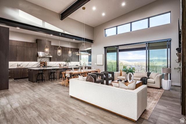 1817 W Skyridge Dr, Heber City, UT 84032 - living area with beamed ceiling, a towering ceiling, light wood-style flooring, and recessed lighting