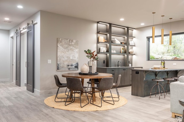 1817 W Skyridge Dr, Heber City, UT 84032 - dining room featuring light wood-style floors, recessed lighting, baseboards, and a barn door