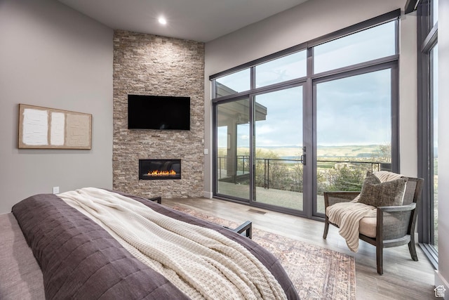 1817 W Skyridge Dr, Heber City, UT 84032 - bedroom with access to outside, light wood-style flooring, a fireplace, and recessed lighting