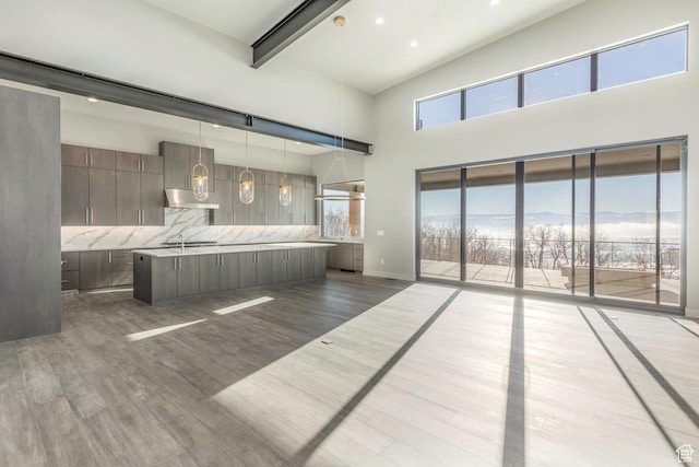 bedroom featuring sink, hardwood / wood-style flooring, access to exterior, a mountain view, and beamed ceiling