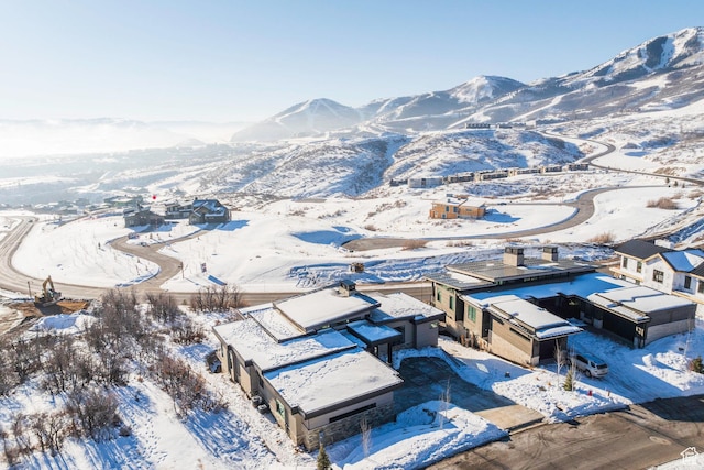 snowy aerial view with a mountain view