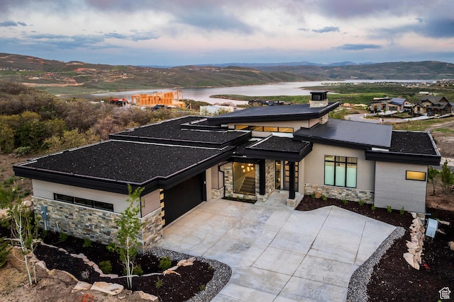 1817 W Skyridge Dr, Heber City, UT 84032 - prairie-style home featuring stone siding, a water and mountain view, concrete driveway, and a garage