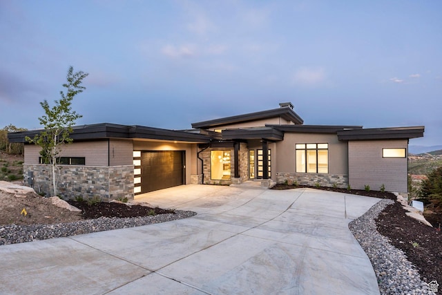 1817 W Skyridge Dr, Heber City, UT 84032 - view of front of house with stone siding, concrete driveway, and a garage