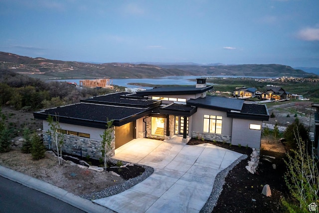 1817 W Skyridge Dr, Heber City, UT 84032 - view of front of house featuring stone siding, a mountain view, concrete driveway, stucco siding, and a garage