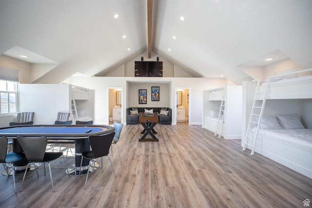 recreation room featuring hardwood / wood-style flooring, high vaulted ceiling, and beamed ceiling
