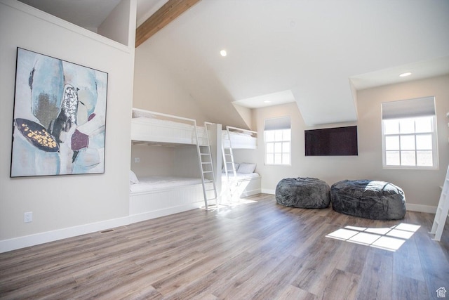 sitting room with high vaulted ceiling, beam ceiling, and light hardwood / wood-style floors