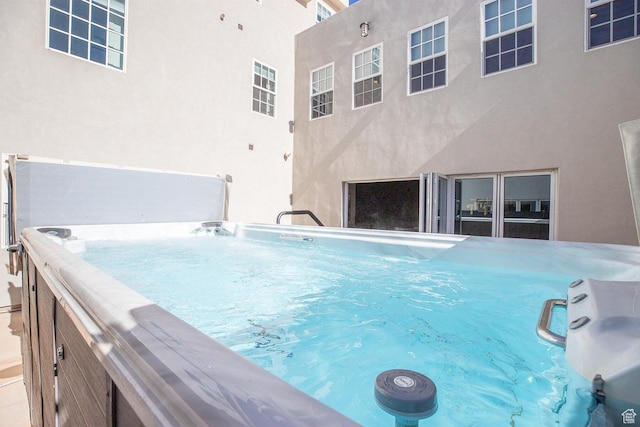 view of swimming pool with a hot tub
