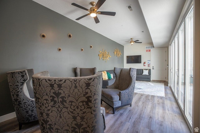 living room featuring ceiling fan and light hardwood / wood-style floors