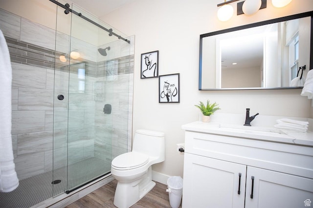 bathroom featuring hardwood / wood-style flooring, vanity, toilet, and an enclosed shower