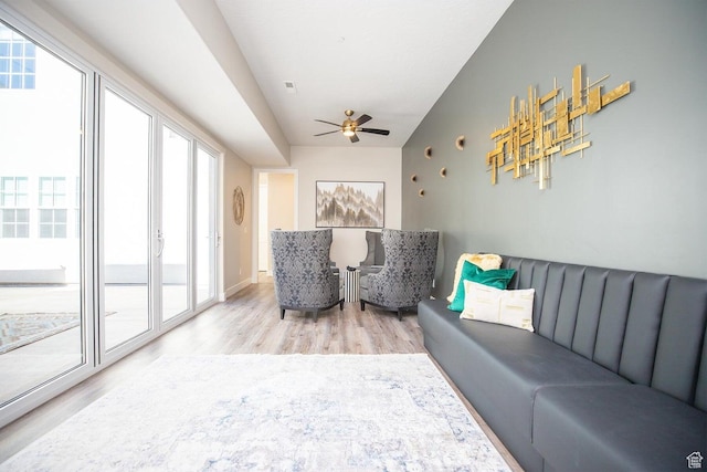 living room featuring light hardwood / wood-style floors and ceiling fan