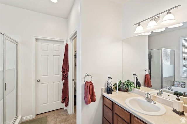 full bath with tile patterned floors, a stall shower, and vanity