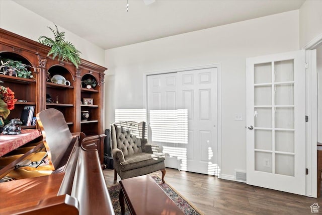 sitting room featuring wood finished floors and visible vents
