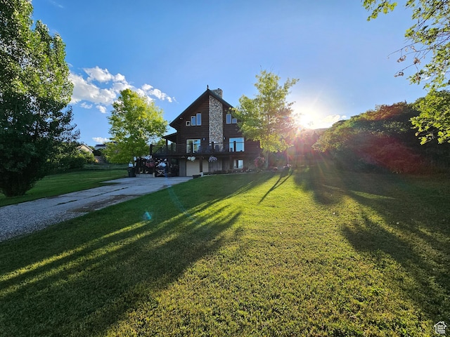 exterior space featuring a wooden deck and a front lawn