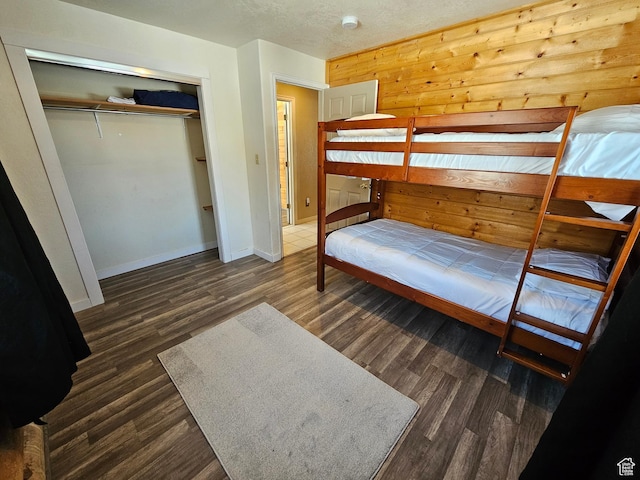 11905 E 24560 N, Fairview, UT 84629 - bedroom with dark wood-type flooring, wooden walls, and a closet