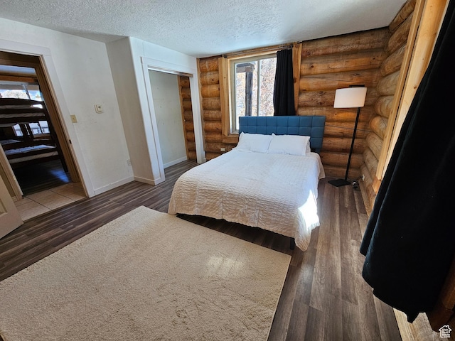 11905 E 24560 N, Fairview, UT 84629 - bedroom with dark hardwood / wood-style floors, rustic walls, and a textured ceiling