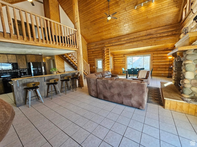 11905 E 24560 N, Fairview, UT 84629 - living room featuring a stone fireplace, high vaulted ceiling, light tile patterned floors, ceiling fan, and log walls