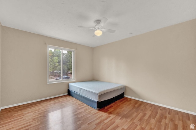 unfurnished bedroom featuring hardwood / wood-style floors and ceiling fan