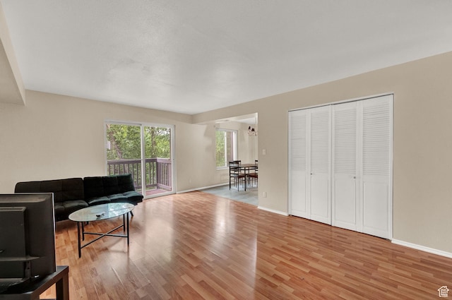 living room featuring an inviting chandelier and light wood-type flooring