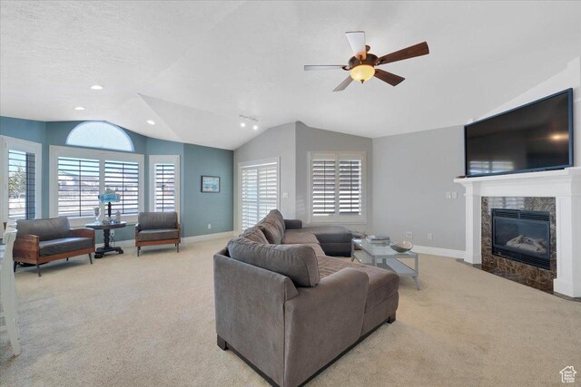 818 Summit Dr, Smithfield, UT 84335 - carpeted living room with vaulted ceiling, a fireplace, baseboards, a ceiling fan, and recessed lighting