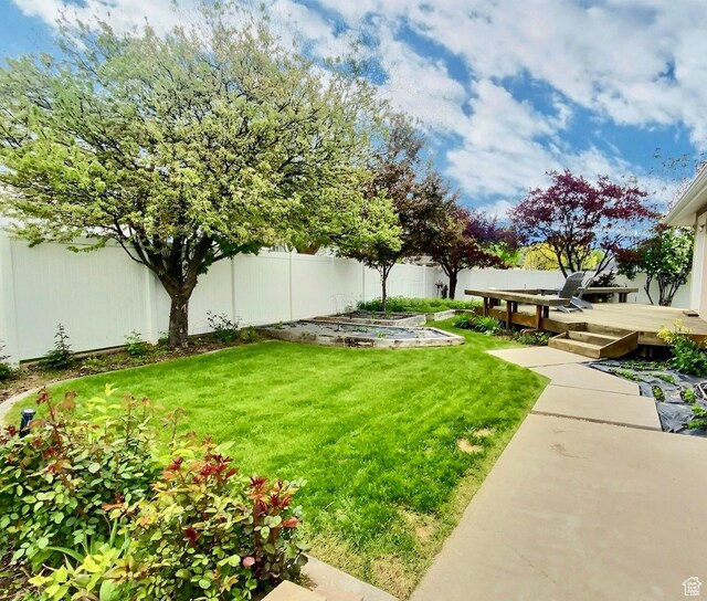 818 Summit Dr, Smithfield, UT 84335 - view of yard with a vegetable garden and a wooden deck