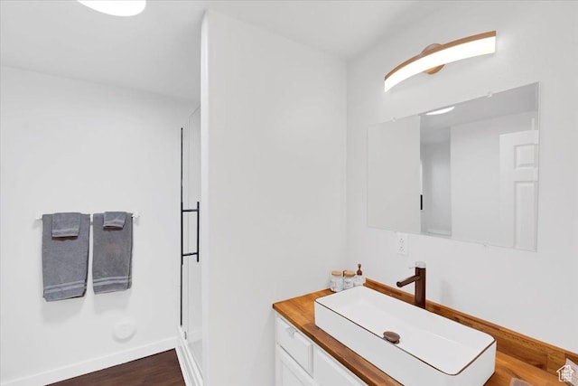 818 Summit Dr, Smithfield, UT 84335 - bathroom featuring vanity, a shower stall, wood finished floors, and baseboards