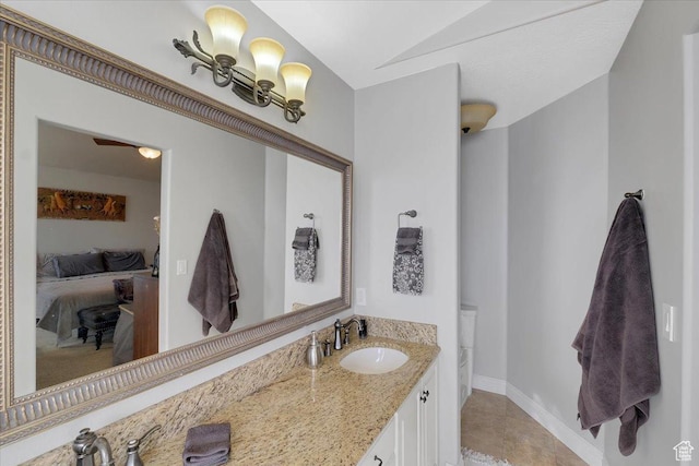 818 Summit Dr, Smithfield, UT 84335 - bathroom with connected bathroom, vanity, tile patterned flooring, and baseboards