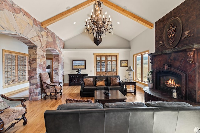 655 W 85 S, Glenwood, UT 84730 - living room with a fireplace, arched walkways, wood finished floors, decorative columns, and a chandelier
