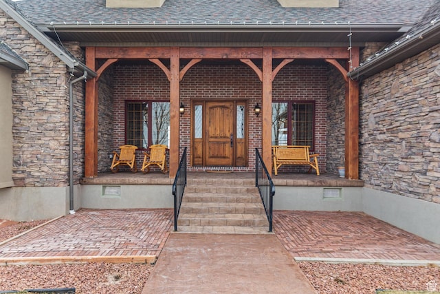 655 W 85 S, Glenwood, UT 84730 - doorway to property with covered porch, roof with shingles, and stone siding