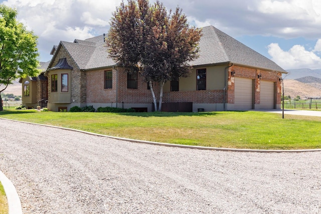 655 W 85 S, Glenwood, UT 84730 - view of front facade with brick siding, an attached garage, a shingled roof, driveway, and a mountain view