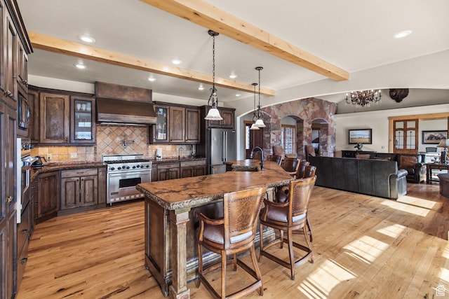655 W 85 S, Glenwood, UT 84730 - kitchen with stainless steel appliances, custom range hood, light wood-type flooring, dark brown cabinetry, and beam ceiling