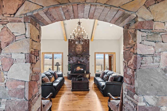 655 W 85 S, Glenwood, UT 84730 - living area featuring wood finished floors, a chandelier, healthy amount of natural light, a fireplace, and beam ceiling