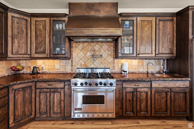 655 W 85 S, Glenwood, UT 84730 - kitchen with designer range, custom exhaust hood, backsplash, glass insert cabinets, and dark brown cabinets