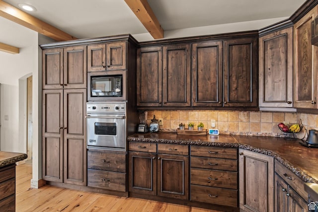 655 W 85 S, Glenwood, UT 84730 - kitchen with oven, black microwave, beam ceiling, backsplash, and dark brown cabinets