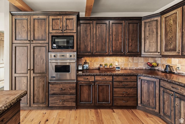 655 W 85 S, Glenwood, UT 84730 - kitchen with stainless steel oven, black microwave, dark brown cabinetry, tasteful backsplash, and light wood finished floors