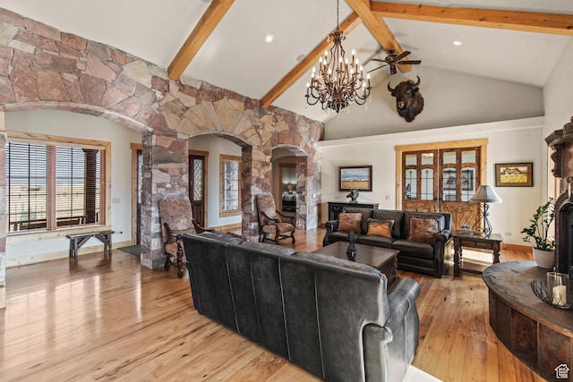 655 W 85 S, Glenwood, UT 84730 - living area with arched walkways, decorative columns, beamed ceiling, light wood-style flooring, and high vaulted ceiling