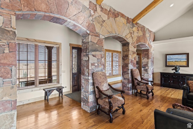 655 W 85 S, Glenwood, UT 84730 - living room featuring arched walkways, wood-type flooring, beam ceiling, high vaulted ceiling, and ornate columns