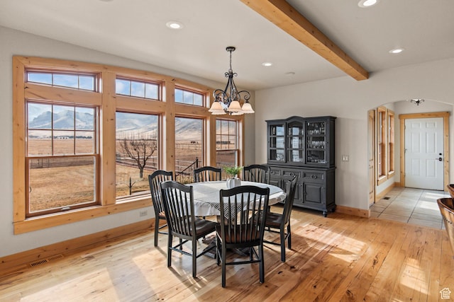 655 W 85 S, Glenwood, UT 84730 - dining room featuring a chandelier, arched walkways, light wood finished floors, recessed lighting, and beam ceiling