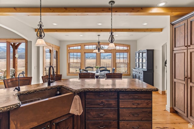 655 W 85 S, Glenwood, UT 84730 - kitchen with beam ceiling, light wood-type flooring, recessed lighting, dark countertops, and arched walkways