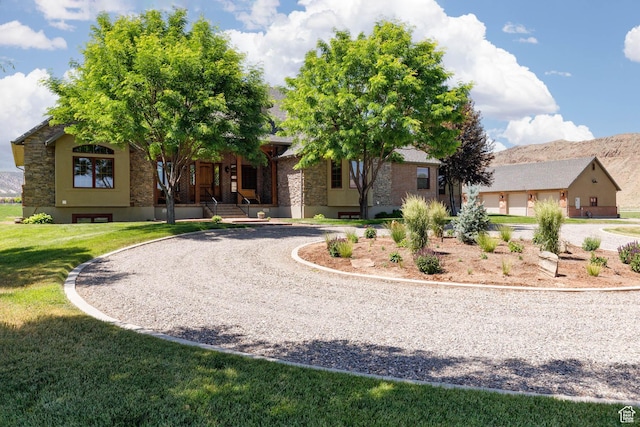 655 W 85 S, Glenwood, UT 84730 - view of front of property featuring curved driveway, a front yard, a porch, and stone siding