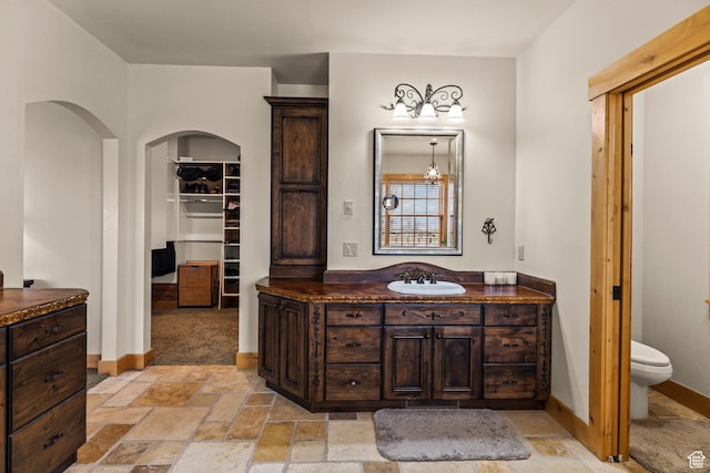 655 W 85 S, Glenwood, UT 84730 - bathroom featuring vanity, stone tile floors, and a walk in closet