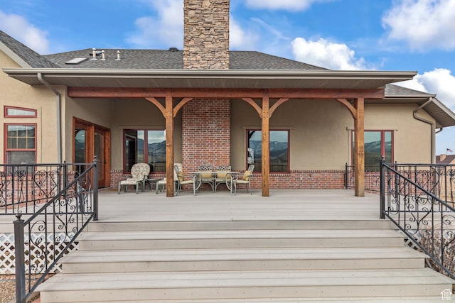 655 W 85 S, Glenwood, UT 84730 - back of property featuring brick siding, stucco siding, a deck, and a shingled roof