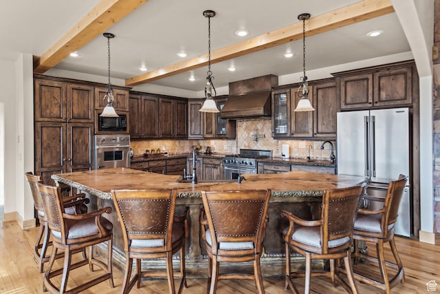 655 W 85 S, Glenwood, UT 84730 - kitchen with high end appliances, premium range hood, beam ceiling, light wood-type flooring, and dark brown cabinetry