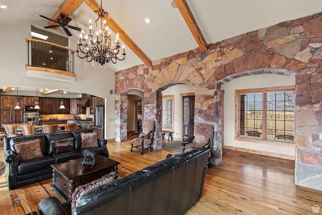 655 W 85 S, Glenwood, UT 84730 - living room with arched walkways, beam ceiling, light wood finished floors, high vaulted ceiling, and a chandelier